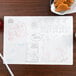 A Hoffmaster Kids Jungle Fun placemat with a drawing on it on a table with chicken nuggets.