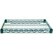 A close-up of a green epoxy coated metal shelf with holes.
