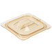 A Carlisle amber plastic lid with a handle on a clear plastic food container.