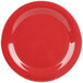 A close-up of a red plate with a white curved line.