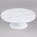 An Elite Global Solutions faux Carrara marble cake stand on a pedestal.