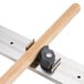 A stainless steel T&S mop hanger with a metal rail and black rubber grips.