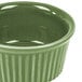 A green fluted China ramekin with a rim.