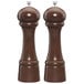 Two Chef Specialties Windsor walnut pepper mills with wooden handles.