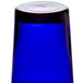 A blue Libbey customizable cooler glass on a table.