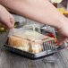 A person holding a Genpak Smart-Set plastic container with food.