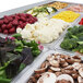 A Turbo Air refrigerated buffet table with trays of vegetables and meat.