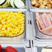 A Turbo Air refrigerated buffet table with trays of food in a buffet.