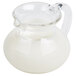 A clear plastic creamer with a handle.