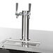 A Beverage-Air black double tap beer dispenser with two silver metal taps on a counter.