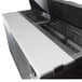 An Avantco stainless steel counter with a white cutting board.