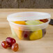 A Pactiv translucent plastic deli container filled with fruit.