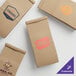 A group of brown Choice paper coffee bags with custom logos.