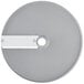 A silver circular Robot Coupe slicing disc with a hole in the center and a white label.