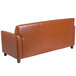 A brown leather Flash Furniture Diplomat sofa with wooden legs.