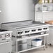 A large stainless steel 60-inch natural gas countertop griddle with multiple thermostatic controls, designed for commercial kitchen use.