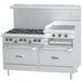 A white U.S. Range gas range with 6 burners, 24" raised griddle, and 2 ovens.