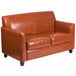 A brown leather Flash Furniture loveseat with wooden legs.