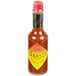 A close-up of a TABASCO® Habanero Hot Sauce bottle with a label.