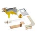 A Manitowoc Ice water valve kit with a yellow and silver metal plate with holes and a nut.