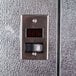 A metal door with a digital temperature control panel.