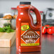 A bottle of TABASCO Buffalo Style Hot Sauce on a counter.