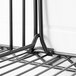 A black Metro wire shelf divider on a metal shelf.