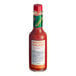A bottle of TABASCO Cayenne Garlic Pepper Hot Sauce on a counter.