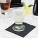 A Libbey Catalina rocks glass filled with a brown liquid and a slice of lime.
