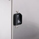 A close-up of a stainless steel door with a black knob on a Bunn automatic coffee brewer.