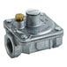 A metal US Range regulator with a brass nut on top.