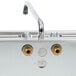 A close-up of a brass faucet on an Eagle Group underbar sink.