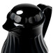 A black pitcher with a white dot on top.