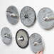 A group of Hobart circular metal plate racks on a white wall.