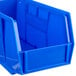 A blue plastic Metro stack bin with a handle.