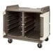 A brown and gray plastic Cambro meal delivery cart with shelves and wheels.