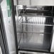 A Turbo Air stainless steel refrigerator with a rack inside.