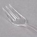 A clear plastic Fineline Tiny Tines tasting fork.
