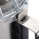 A close up of a stainless steel Robot Coupe cutter bowl kit.