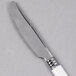 A WNA Comet Reflections Duet plastic knife with a silver blade and white handle.