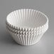 A stack of white fluted baking cups.