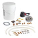 A Cleveland Boiler Service Kit with plumbing parts and a hose in a bucket of water.