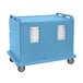 A slate blue Cambro meal delivery cart with two doors and wheels.