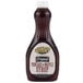 A Golden Barrel Pancake and Waffle Syrup 24 oz. bottle with a white cap filled with brown liquid.