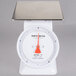 A white Cardinal Detecto mechanical portion scale with metal accents on a counter.