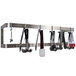 A stainless steel Advance Tabco double line pot rack with utensils hanging on it.