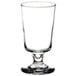 A Libbey footed highball glass with a small rim on top.