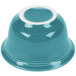 A turquoise bowl with a white rim.