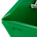 A green plastic bin with a white plastic sieve and handle.