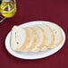 Sliced bread on a Thunder Group white melamine oval platter.